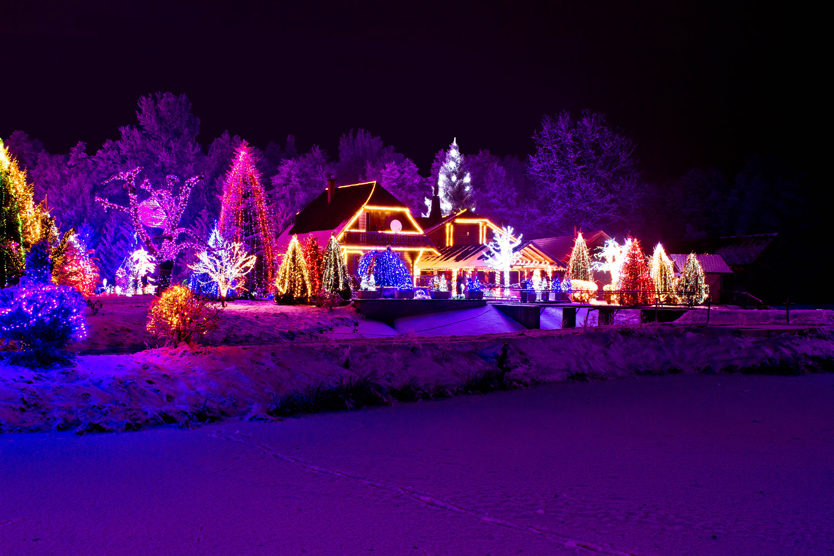 Christmas fantasy - park, forest & lodge in xmas lights